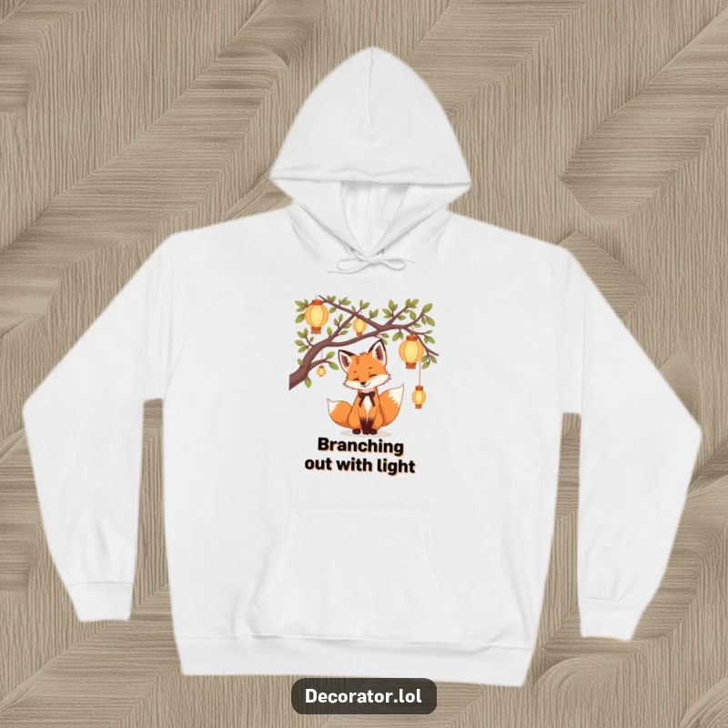 Funny Hoodie with a playful fox cub hanging delicate lanterns on tree branches, creating a warm, humorous, and enchanting atmosphere.